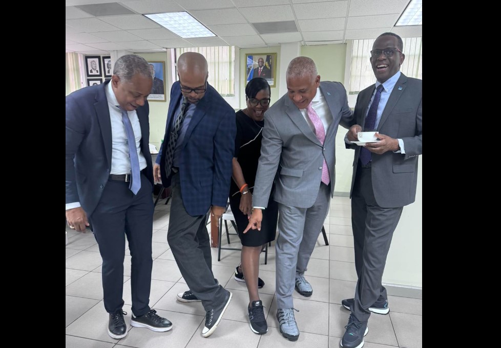 Philip J. Pierre and colleagues pose with sneakers.