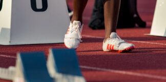 Athlete standing by race starting block.