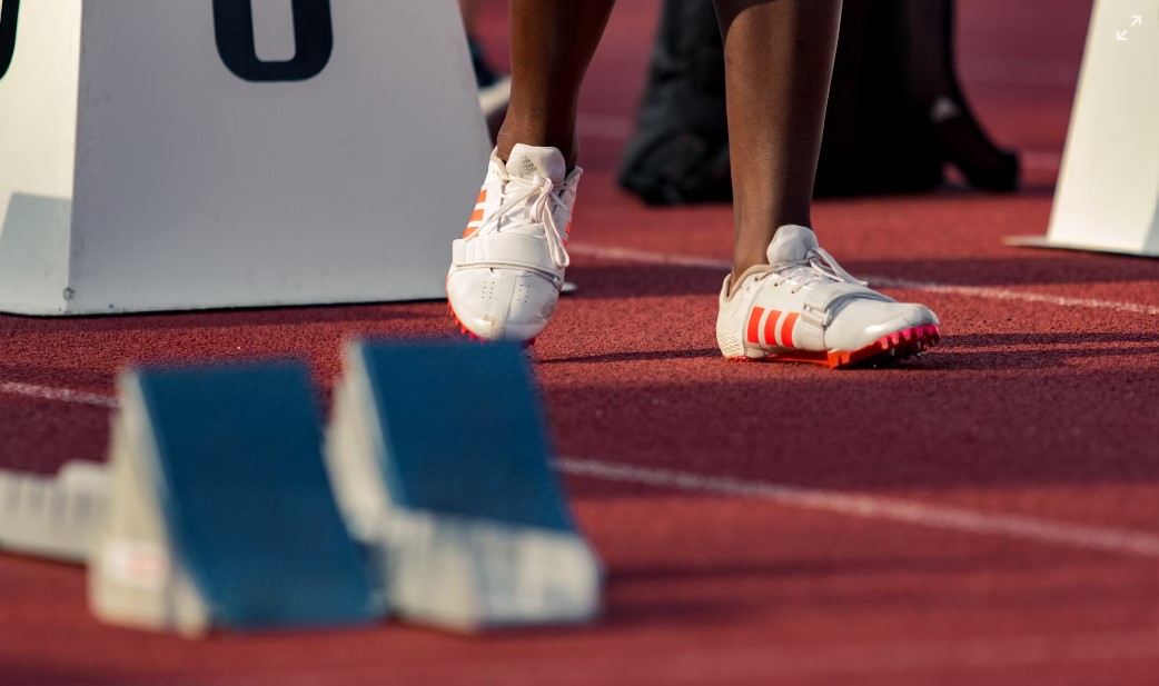 Athlete standing by race starting block.