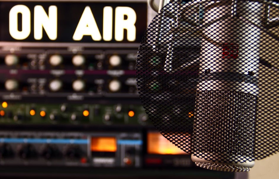 On Air sign beside microphone in studio.