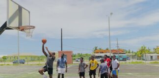 Young people on basketball court during Vieux Fort camp.