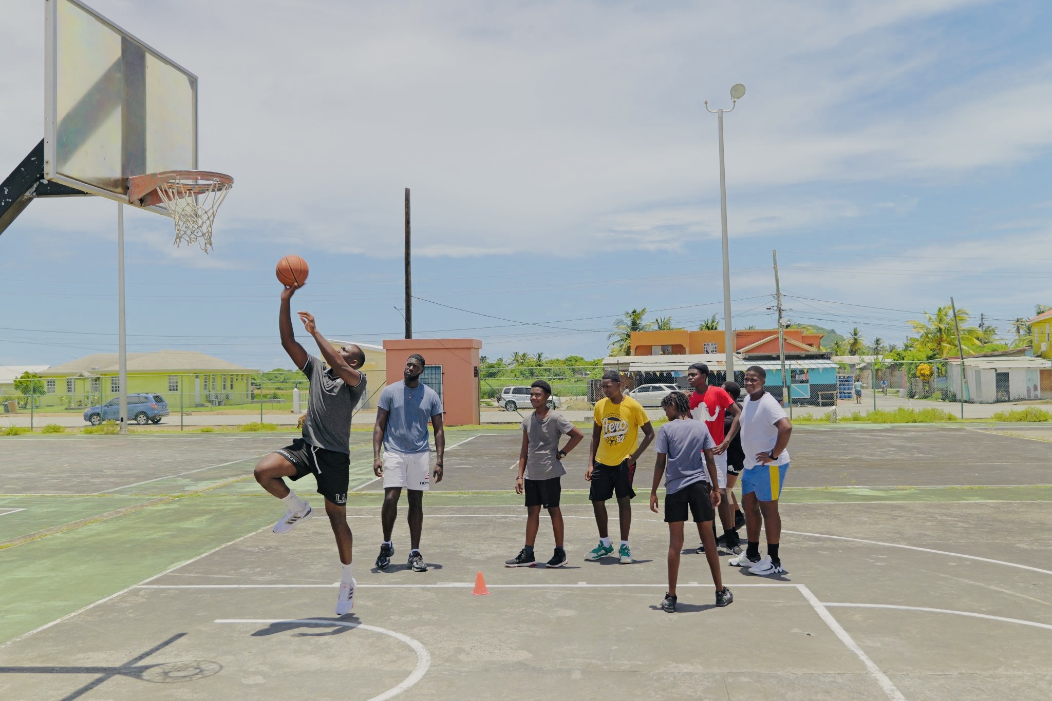 Young people on basketball court during Vieux Fort camp.