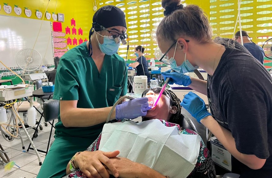 Dentists looking after patient's teeth.