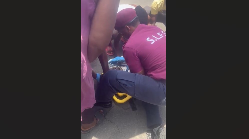 Emergency personnel tend to a biker on the ground after he collided with e vehicle at Praslin.