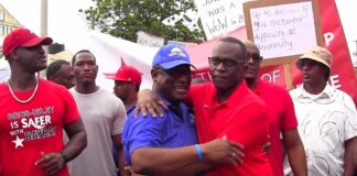 Stephenson King and Philip J. Pierre embrace during Sunday's SLP 'March for Progress'