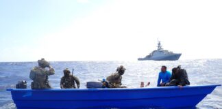 United States Coast Guard officials board drug smuggling vessel.