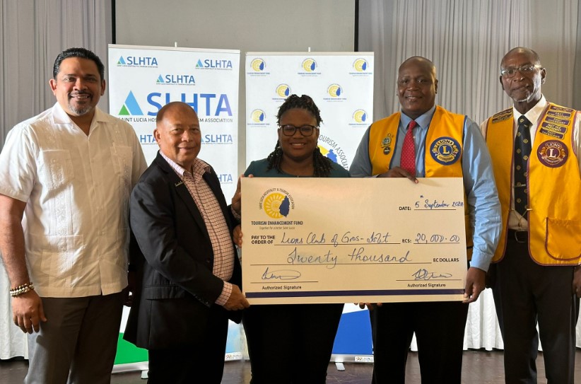 Cancer screening project launch attendees pose with sponsorship cheque.