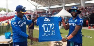 Saint Lucia Kings players hold up jersey.