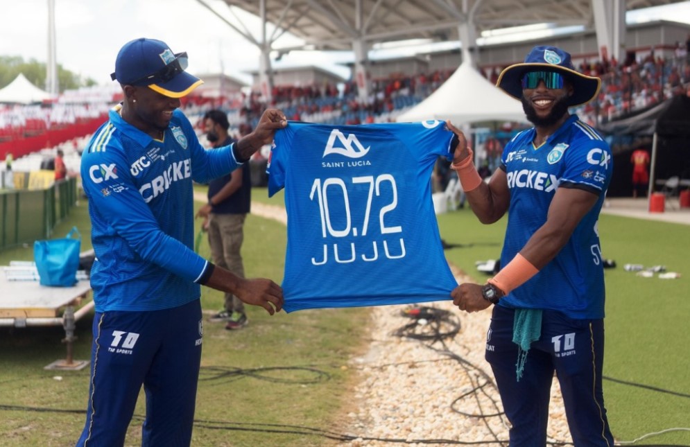 Saint Lucia Kings players hold up jersey.