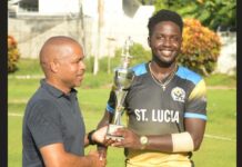 Kimani Melius (right) with Cricket Association president, Wayne Auguste.