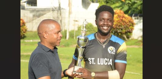 Kimani Melius (right) with Cricket Association president, Wayne Auguste.