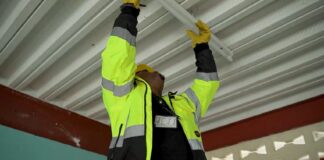 LUCELEC Employee installing light fixture in a school building.