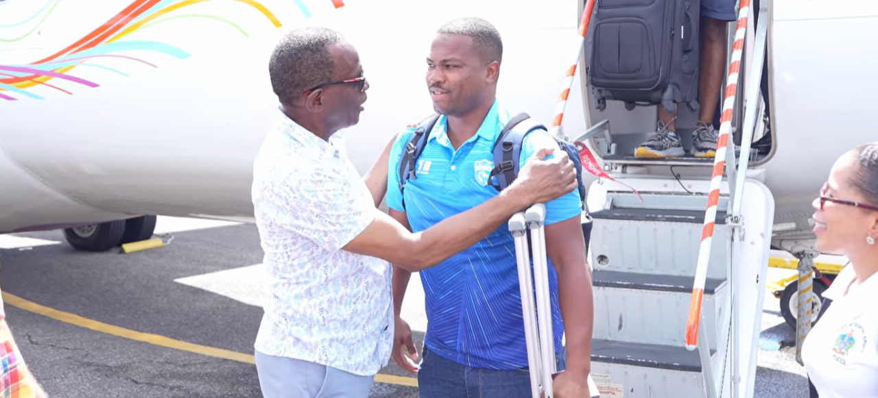 Prime Minister Philip J. Pierre greets Johnson Charles on his arrival.