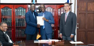 Prime Minister Philip J. Pierre receives Taiwanese grant funding cheque.