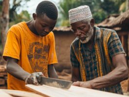 Older man teaches boy wood craft.