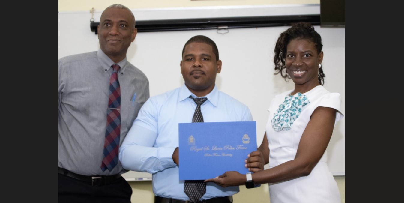 Police officer receives certificate after graduating from training course.